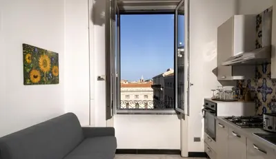 a living room with a couch and a window at Ai quattro canti di città, appartamento in centro in Palermo