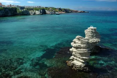 a rock formation in the water near the shore at Villa Linda, Exceptional Sea-view in Terrasini