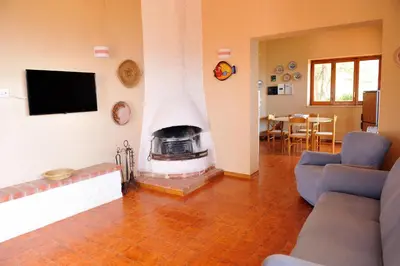 a living room with a fireplace with a tv in it at Villa Linda, Exceptional Sea-view in Terrasini
