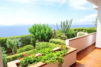 a balcony with plants and a view of the ocean at Villa Linda, Exceptional Sea-view in Terrasini