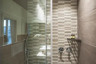 a bathroom with two sinks and a shower at Ci'Cala House in Palermo