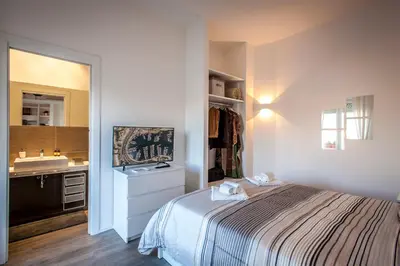a bedroom with a bed and a sink in it at Ci'Cala House in Palermo