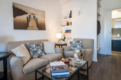 a living room with a couch and a table at Ci'Cala House in Palermo