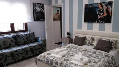 a bedroom with a bed and a couch at B&B A casa dell'artista in Casteldaccia