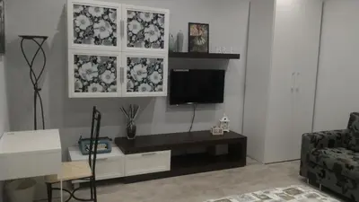 a living room with a tv on a wall at B&B A casa dell'artista in Casteldaccia