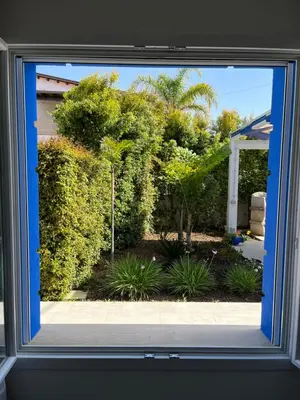 a view of a garden through a window at Villetta Azzurra in Alcamo Marina