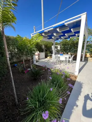 a patio with a blue and white pergola at Villetta Azzurra in Alcamo Marina