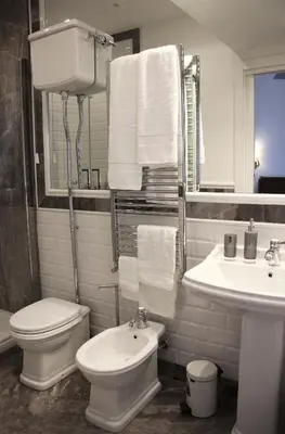 a white bathroom with a toilet and a sink at B&B Vivere Palermo in Palermo