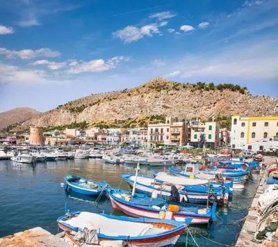 a bunch of boats are docked in a harbor at Villa Rosemada, Mondello in Palermo