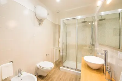 a bathroom with a toilet and a sink and a shower at Loft 18 by Wonderful Italy in Palermo