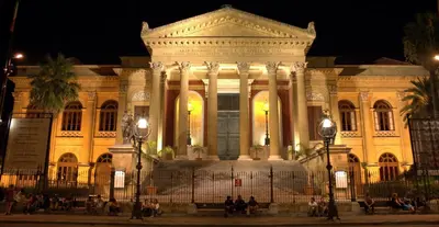 a large building at night with people in front at Loft 18 by Wonderful Italy in Palermo