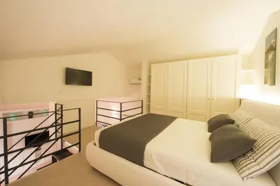 a bedroom with a bed and a tv on the wall at Loft 18 by Wonderful Italy in Palermo