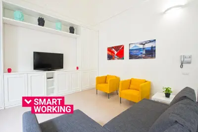 a living room with a couch and two yellow chairs at Loft 18 by Wonderful Italy in Palermo