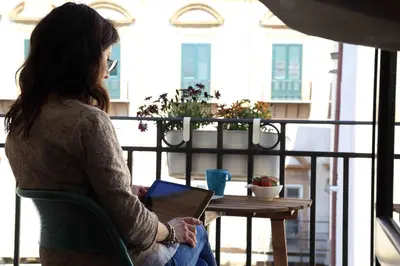 a table with breakfast food on a balcony at Jardin De France in Palermo