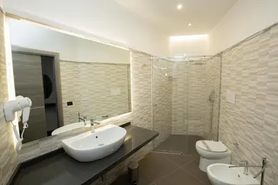 a bathroom with a sink and a toilet and a shower at Hotel Sporting Club in Altavilla Milicia