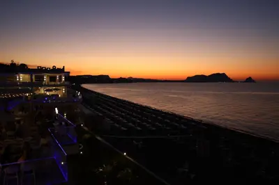 a view of the ocean at sunset from a resort at Hotel Sporting Club in Altavilla Milicia