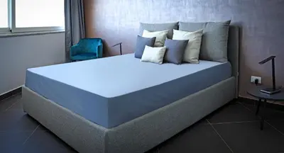 a large bed in a room with a blue mattress at Hotel Sporting Club in Altavilla Milicia