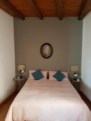 a bedroom with a large bed with blue pillows at Boutique House Montevergini in Palermo