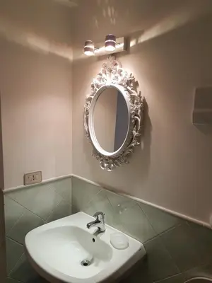 a bathroom with a sink and a mirror on the wall at Boutique House Montevergini in Palermo