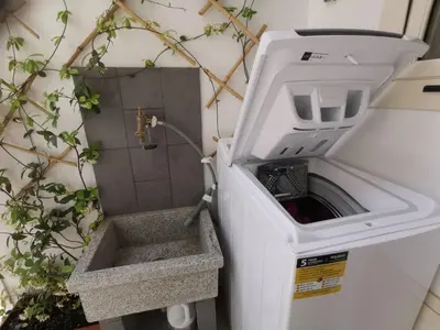 a washing machine sitting next to a plant at se vi pare in Palermo