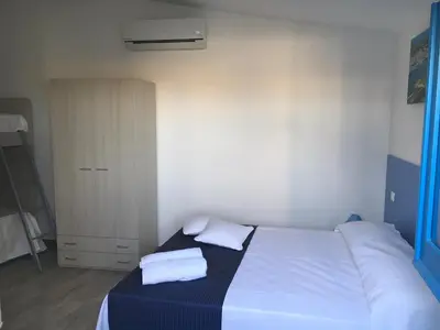 a bedroom with a bed with two pillows on it at Le Case di Palma - Viola in San Vito lo Capo
