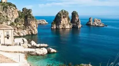 a view of the ocean with rocks in the water at Le Case di Palma - Viola in San Vito lo Capo