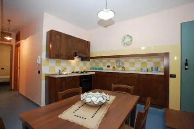 a kitchen with a wooden table with a bowl on it at La Chiusa Case Vacanze in Castellammare del Golfo