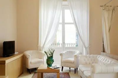 a living room with a couch and two chairs and a window at Palazzo Brunaccini Boutique Hotel in Palermo