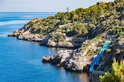 an island with a blue bridge in the water at CDSHotels Terrasini - Città del Mare in Terrasini
