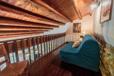a living room with a blue couch on a balcony at Poggio Pozzetti in Lascari