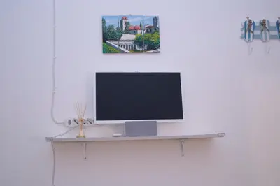 a computer monitor sitting on a shelf on a wall at Mediterraneo in Palermo