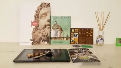 three books sitting on a table next to a table with a book at Mediterraneo in Palermo
