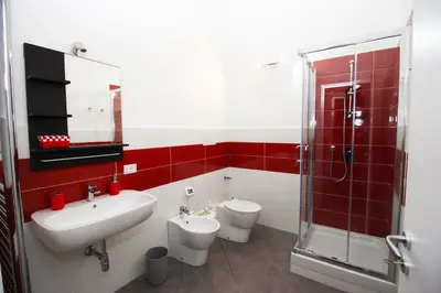 a bathroom with two toilets and a sink and a shower at Oasi del Turista in Palermo
