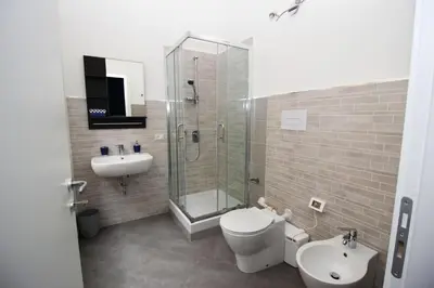 a bathroom with a toilet and a sink and a shower at Oasi del Turista in Palermo