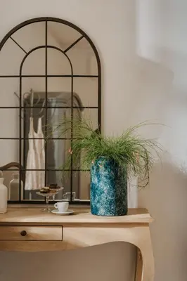 a table with a vase with a plant on it at Palazzo Natoli Boutique Hotel in Palermo