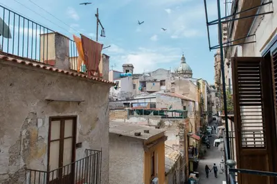 an alleyway in an old city with buildings at B&B Malvasia in Palermo