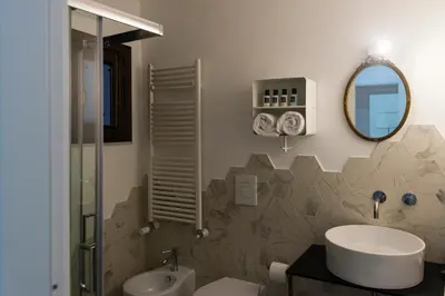 a bathroom with a sink and a mirror at B&B Malvasia in Palermo