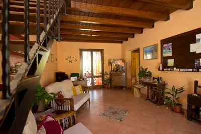 a living room with a couch and a table at ilgiardinodellanonna in Castelluzzo