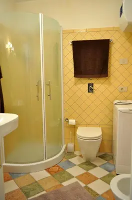 a bathroom with a shower and a toilet at Villa Le Meraviglie in San Vito lo Capo