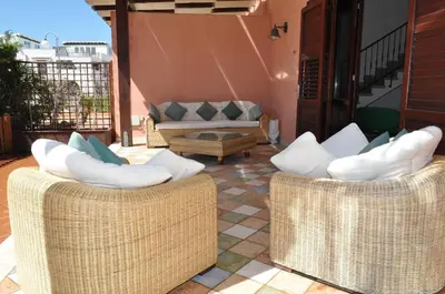 two wicker chairs sitting on top of a patio at Villa Le Meraviglie in San Vito lo Capo