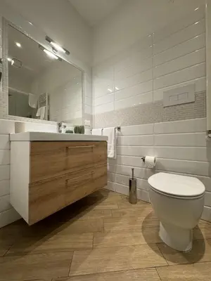 a bathroom with a toilet and a sink and a mirror at Novelli 36 in Palermo