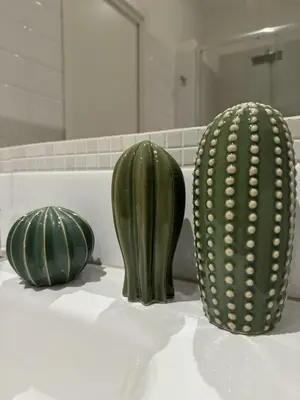 two green cactuses sitting on a counter in a bathroom at Novelli 36 in Palermo