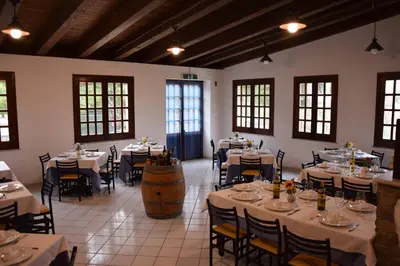 a restaurant with tables and chairs and a barrel at Camping Village La Pineta in San Vito lo Capo