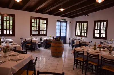 a dining room with tables and a wine barrel at Camping Village La Pineta in San Vito lo Capo