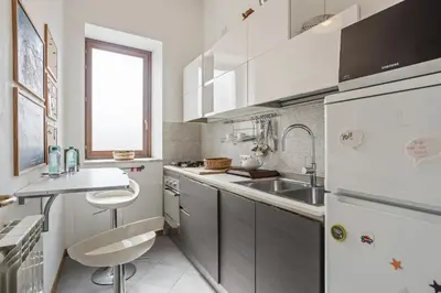 a white kitchen with a sink and a refrigerator at Appartamento Moderno alla Cala by Wonderful Italy in Palermo