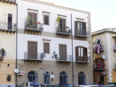 a large white building with windows and balconies at Appartamento Moderno alla Cala by Wonderful Italy in Palermo