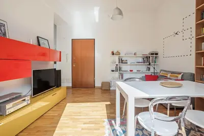 a living room with a white table and a tv at Appartamento Moderno alla Cala by Wonderful Italy in Palermo