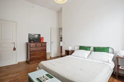 a bedroom with a bed and a dresser at Appartamento Moderno alla Cala by Wonderful Italy in Palermo