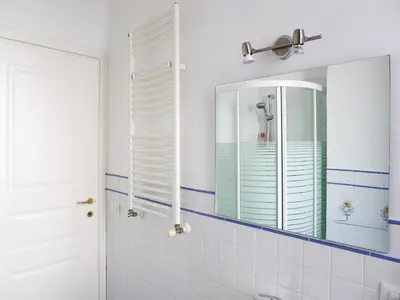 a bathroom with a mirror and a sink at Appartamento Moderno alla Cala by Wonderful Italy in Palermo