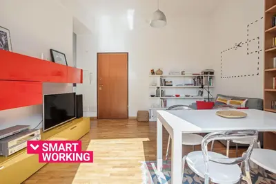a living room with a white table and a tv at Appartamento Moderno alla Cala by Wonderful Italy in Palermo